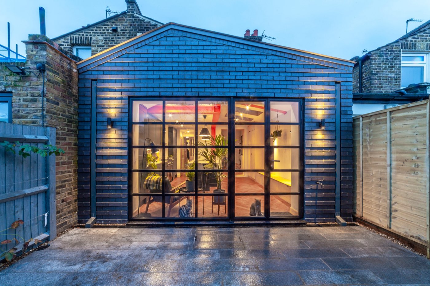 Rear extension with steel-framed glazing lit at dusk, a LINX project on Hedgley Street