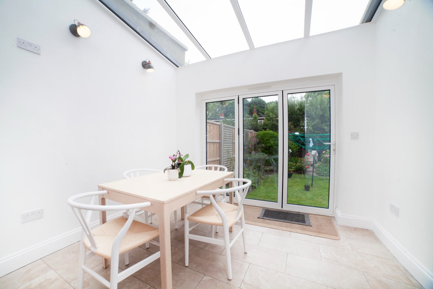 Dining space under a glazed roof with doors to the garden, Sotheby Road, by LINX