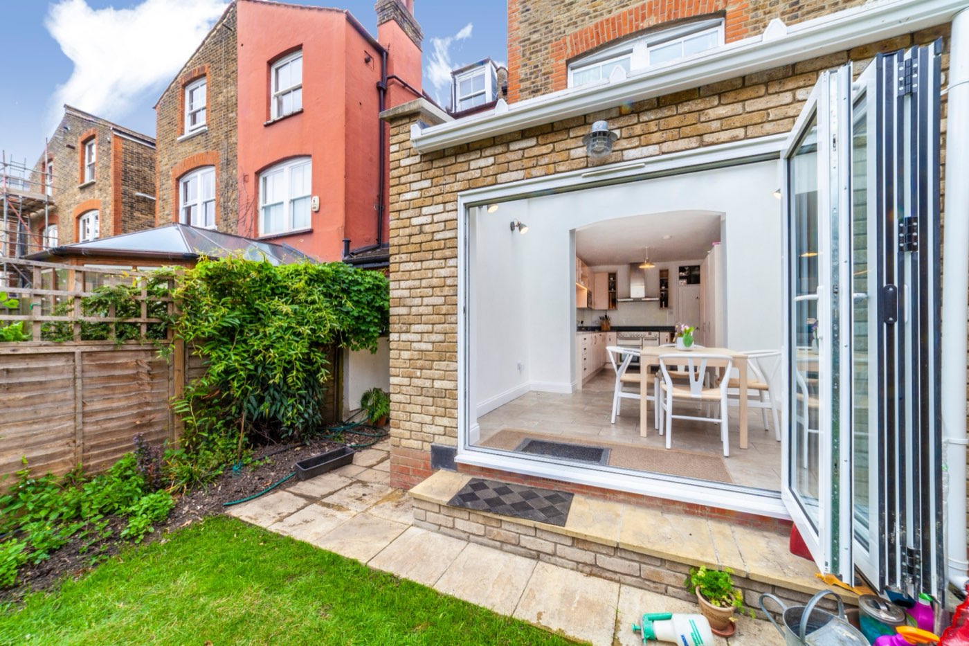 Brick rear extension with bi-fold doors folded open to the garden, Sotheby Road, by LINX