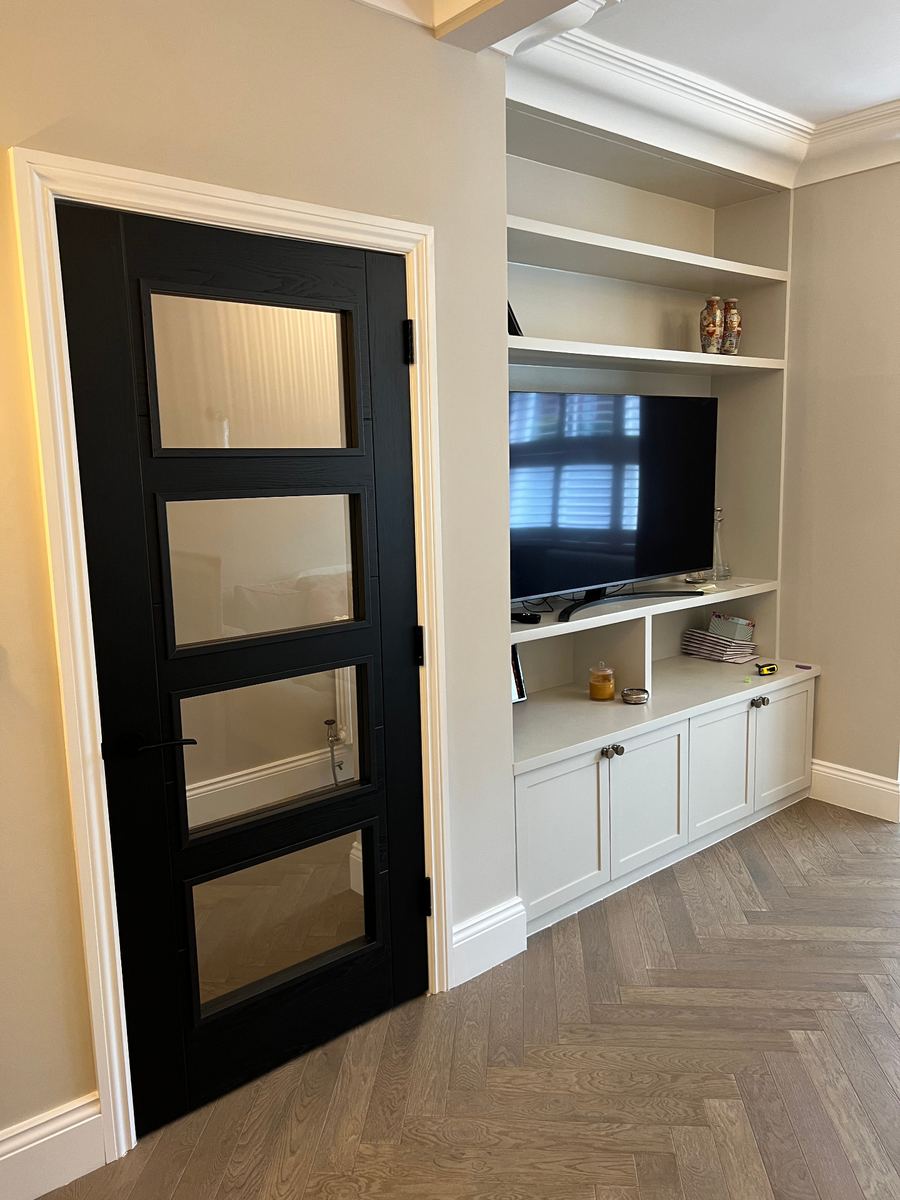 Herringbone floor, a black glazed door and built-in joinery in a LINX project