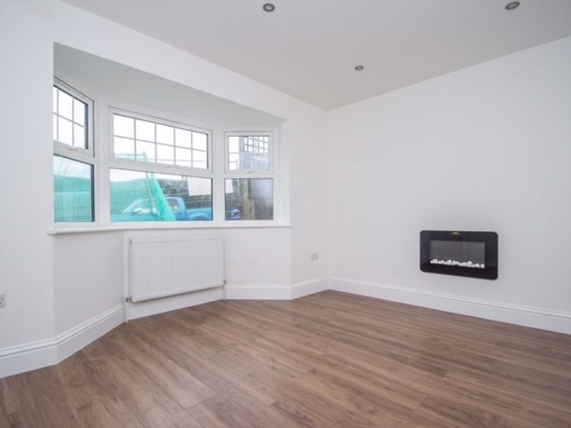 Living room with a bay window in the Sutton new build by LINX