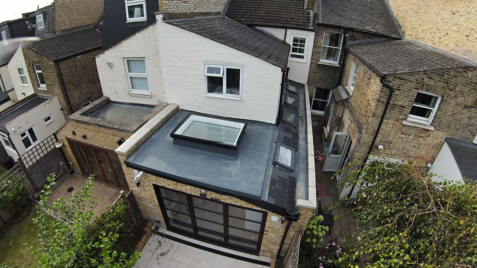 Aerial view of a LINX rear extension with a flat roof light and black-framed glazed doors